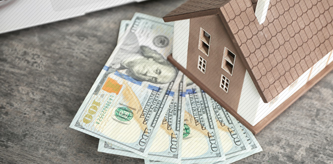 A model house with hundred dollar bills underneath